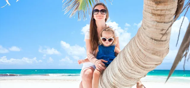 Mother and child perched on a palm tree